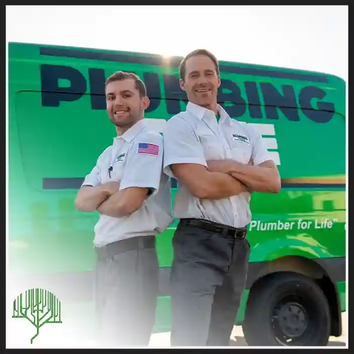 Plumbing Tree technician in uniform standing with arms crossed in front of a branded green service van