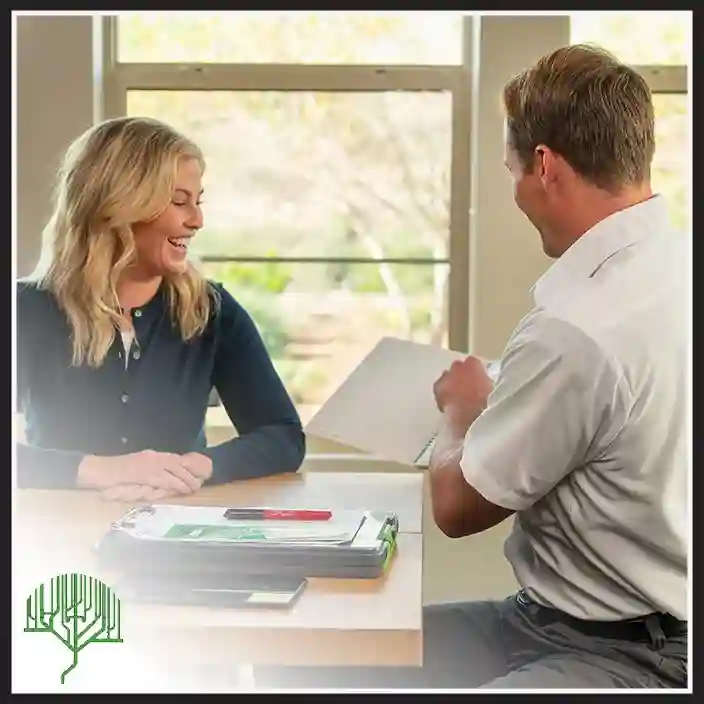Plumbing Tree plumber discussing a service estimate with a homeowner