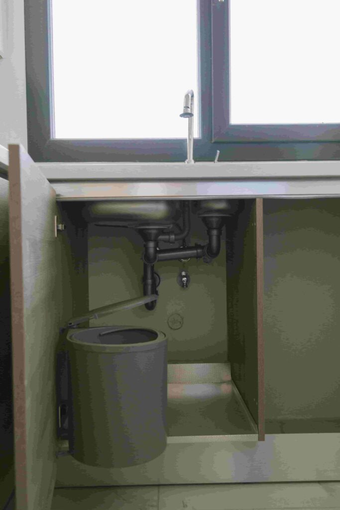 under-sink plumbing pipes and drain connections
