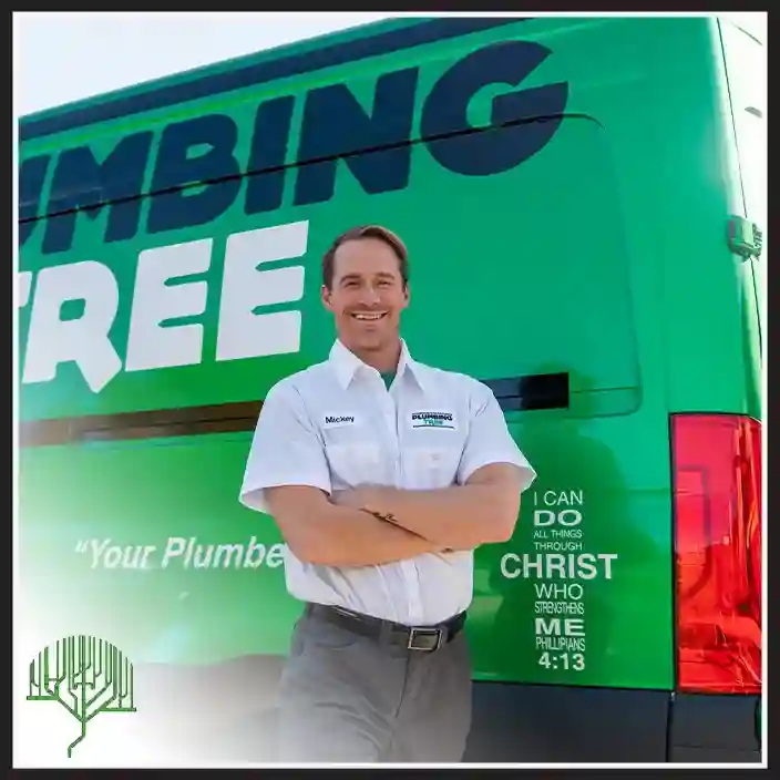 Plumbing Tree technician smiling next to an open service van