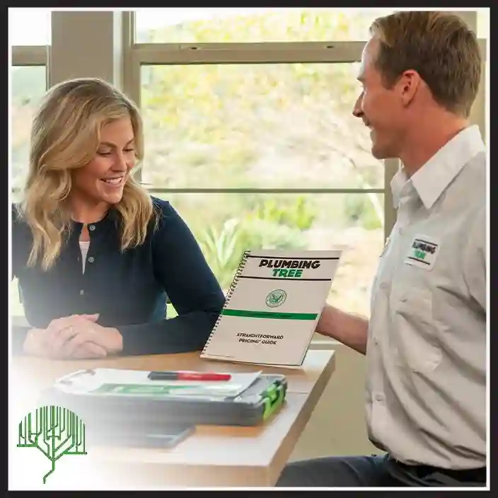 Plumbing Tree plumber reviewing a service plan with a customer at a table